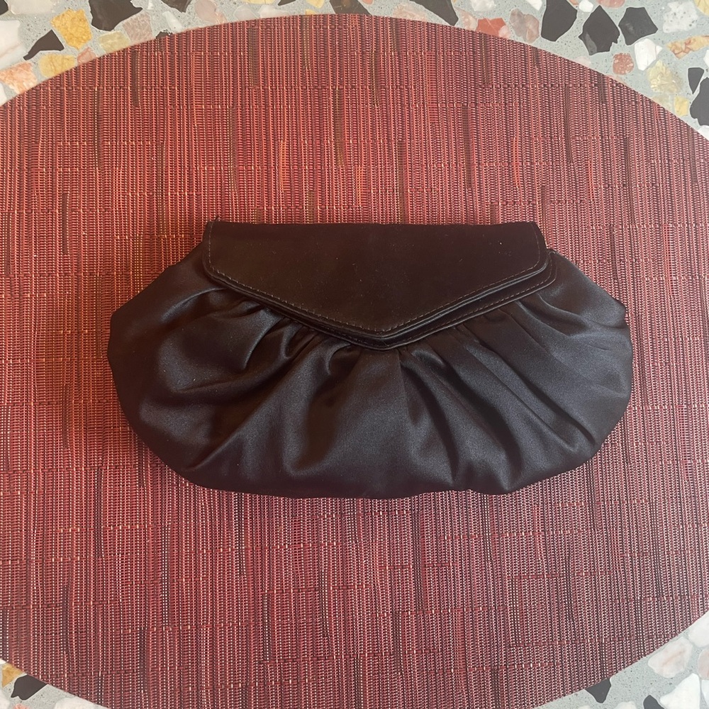 Dainty black satin clutch by Laura Merkin